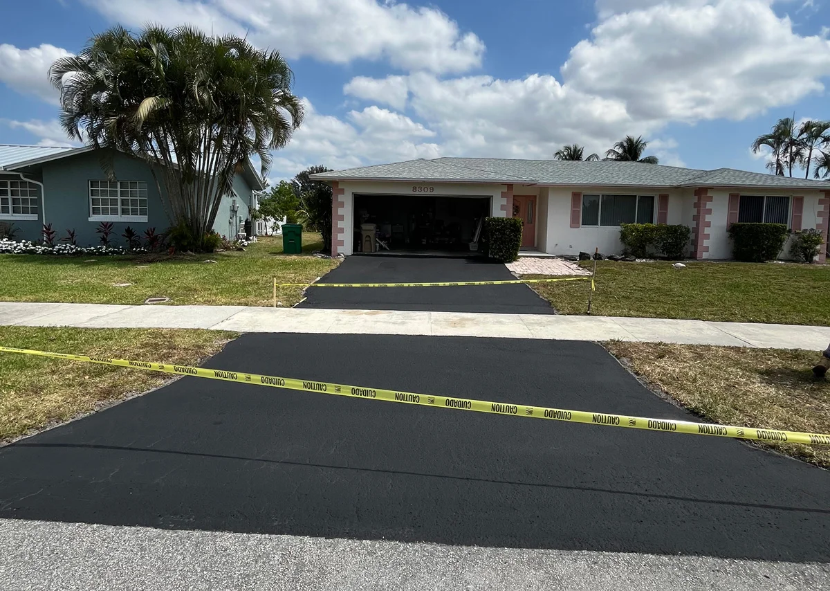 Freshly sealcoated driveway with caution tape