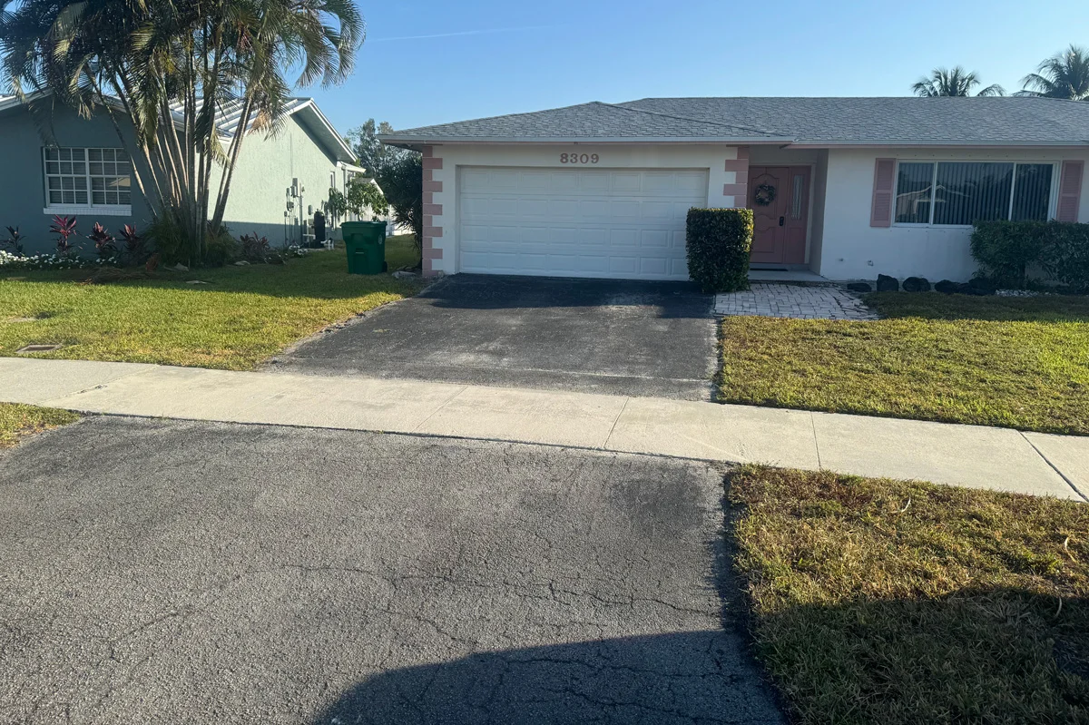 Faded and worn residential driveway before sealcoating